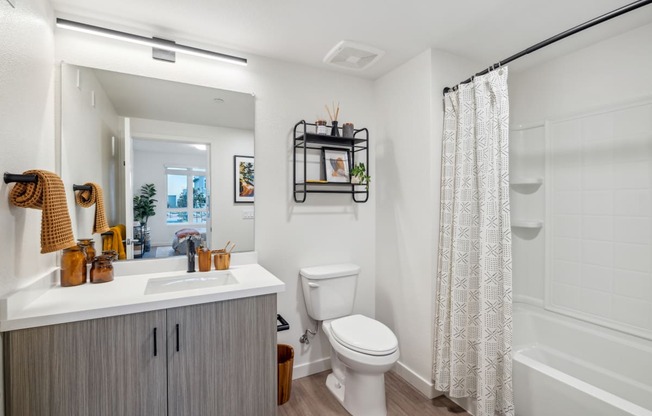 a bathroom with a toilet and a shower and a sink