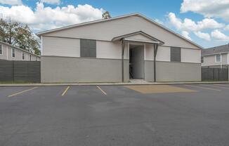 an empty parking lot in front of a house