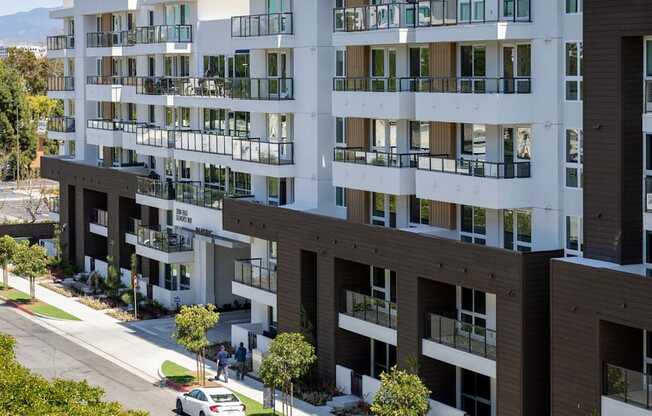 A modern apartment building with a car parked on the street in front. at Elements Apartments*, California, 92612