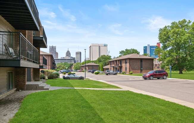 a lawn in front of a building with a view of the city in the background at Lafayette Park Place, Detroit, MI, Michigan