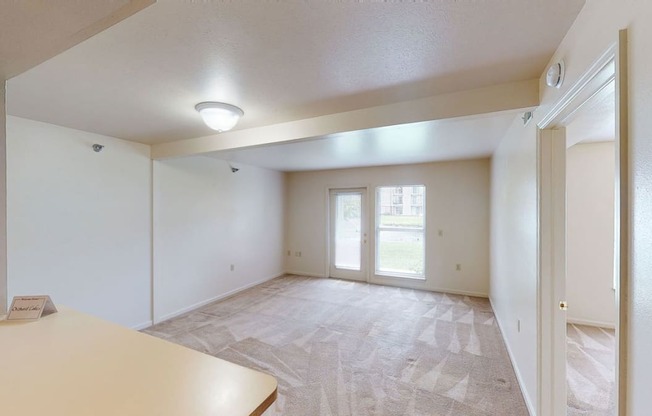 Two bedroom living room and dining room leads to private patio