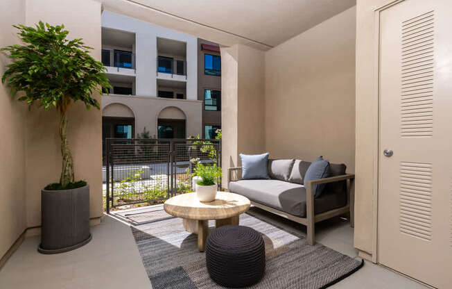 A small balcony with a table and chairs.