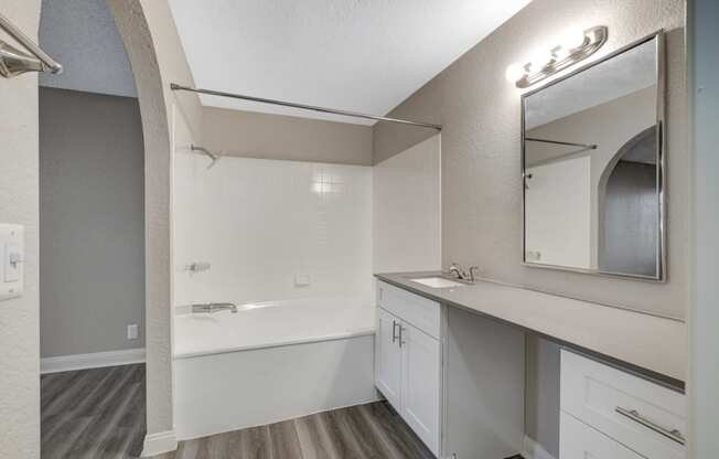 a bathroom with a bathtub and a sink