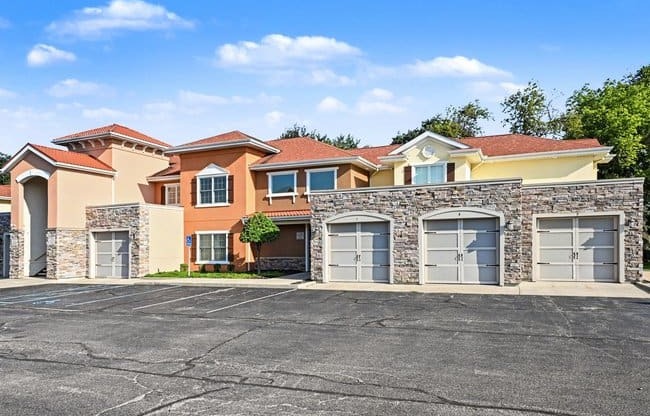 Exterior of The Residences at Toscana Park apartments with connected parking garages in Granger, Indiana.