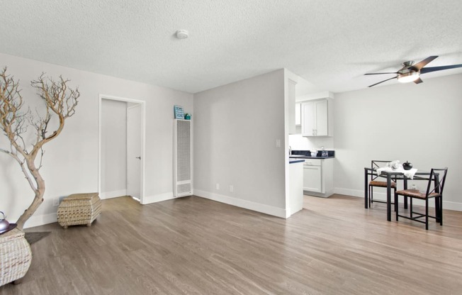 the living room and dining room of an apartment