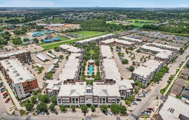 an aerial view of a city with buildings and a pool