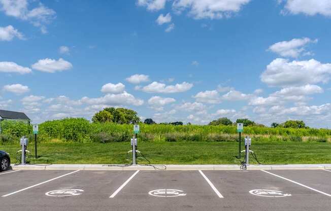 A parking lot with a car parked and a bike rack.