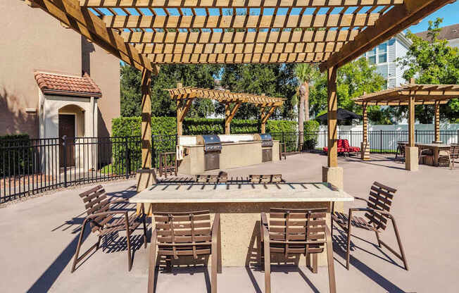 Outdoor grilling and dining pergolas with tables and seating