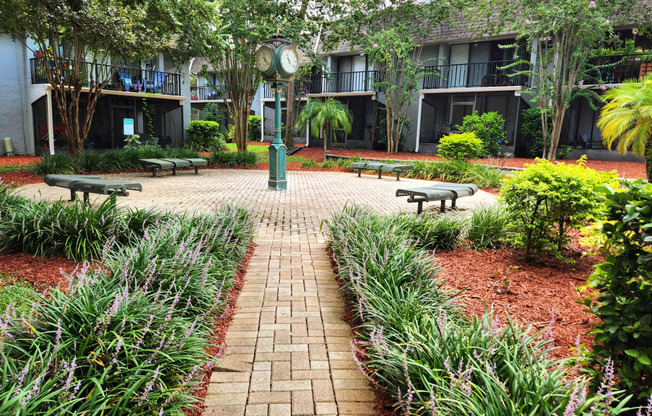 a courtyard with benches and a clock