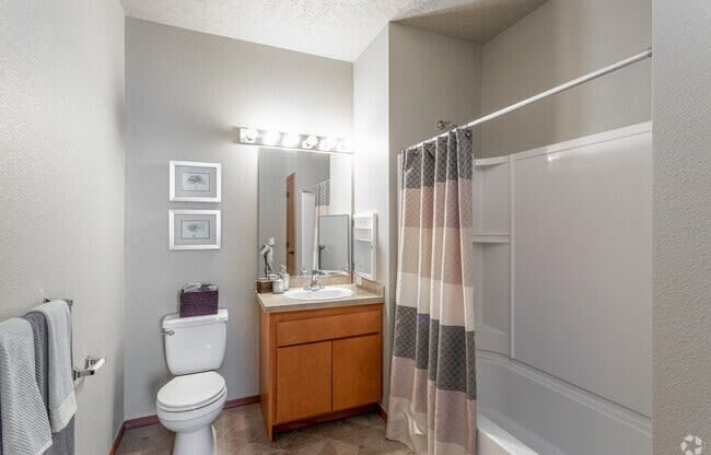 a bathroom with a toilet sink and shower