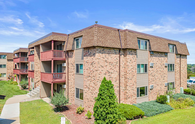 Apartment complex with a white car parked in the driveway.