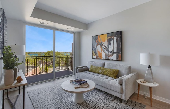 a living room with a couch coffee table and a large window