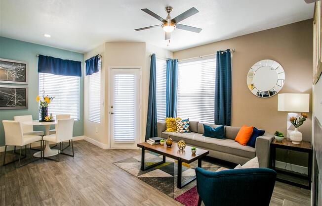 a living room filled with furniture and a ceiling fan