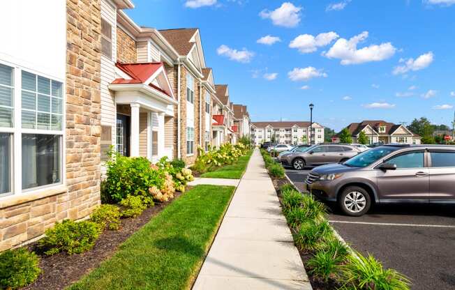 a row of houses with cars parked in front of them