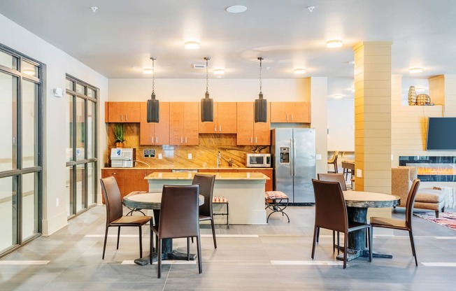 Centre Pointe Apartments clubhouse kitchen area with a breakfast bar and tables