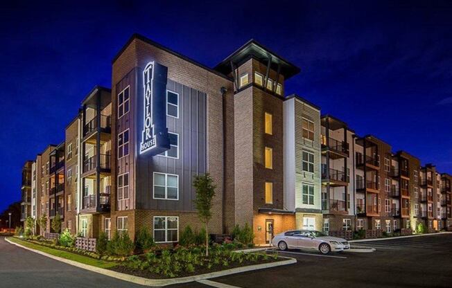 a rendering of an apartment building at night