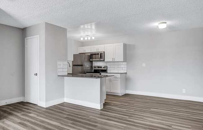 an open kitchen with an island and stainless steel appliances