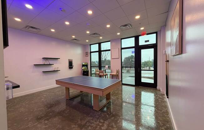 A conference room with a table and chairs.