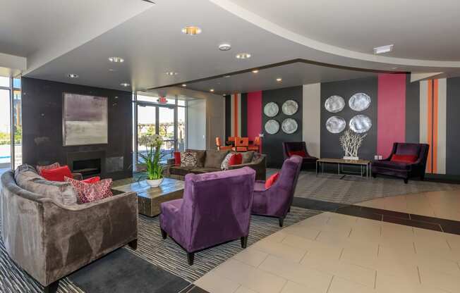 a lobby with couches and chairs and a fireplace