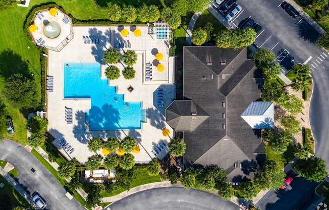 A large building with a pool in front of it.