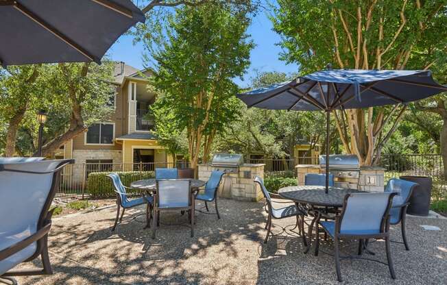 an outdoor patio with tables and chairs and umbrellas