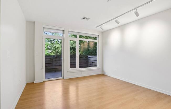 Living room with a sliding glass door at Park77 Apartments, Massachusetts