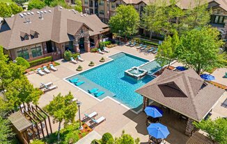 an aerial view of the pool at the resort on a sunny day