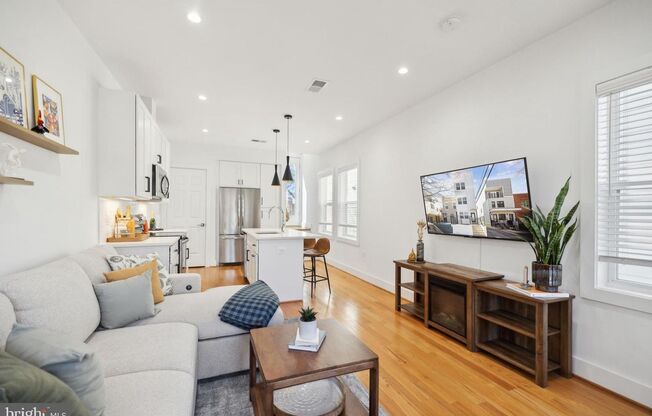 Welcome to 1181 Neal Street NE, a stunning 3-level townhome offering a private rooftop deck with breathtaking skyline views and off-street parking.