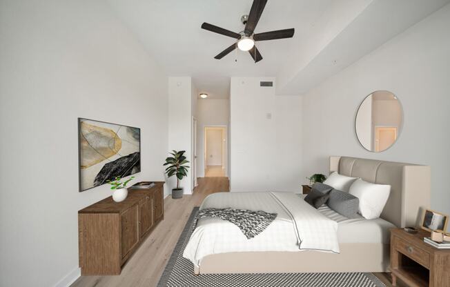 a bedroom with a large bed and a ceiling fan