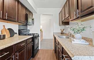 a kitchen with wooden cabinets and granite counter tops