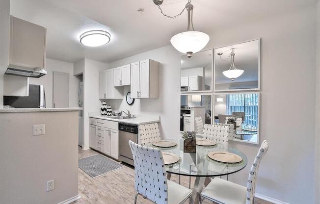 Hayward, CA Apartments - Renovated Kitchen Has Wood-Inspired Flooring, White Cabinets, Stainless Steel Appliances, Dishwasher, And A Washer And Dryer Unit