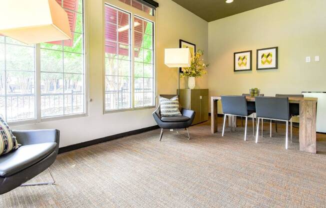 A waiting room with a chair, a table, and a lamp.