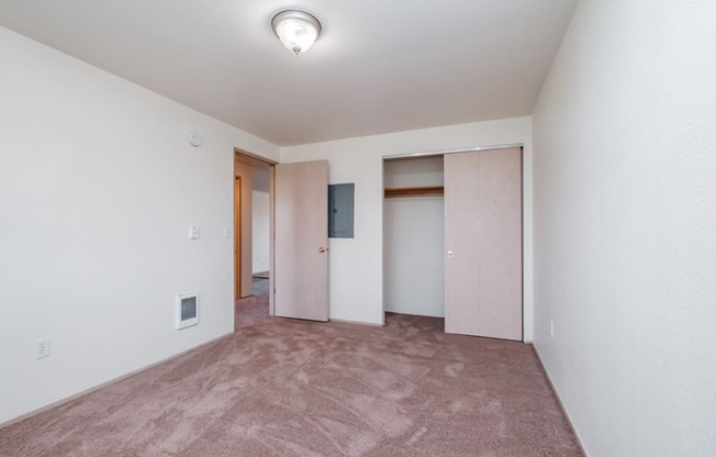 a bedroom with a carpeted floor and white walls