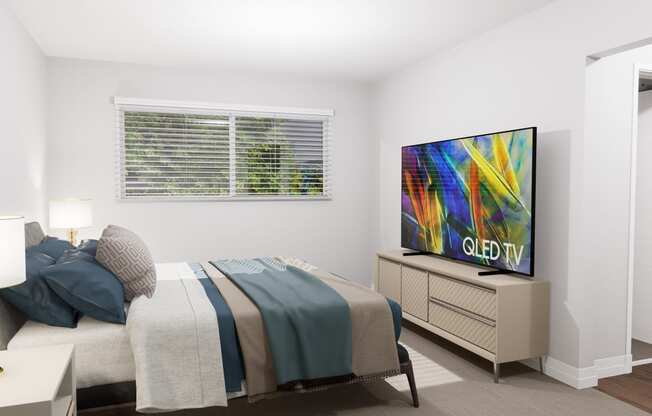 a bedroom with a bed and a tv in it