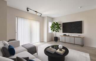 A modern living room with a black coffee table and a white sofa.