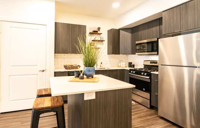 a kitchen with stainless steel appliances and a white counter top