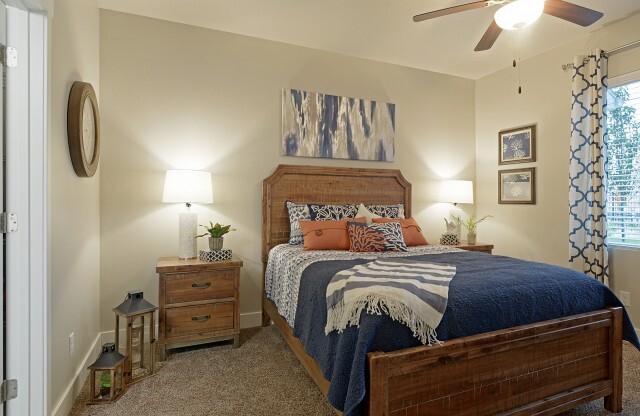 Master bedroom with queen bed, two nightstands, and large window