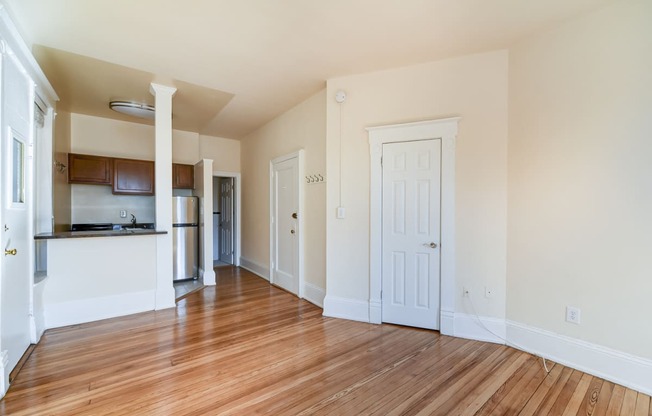 vacant living area with hardwood floors and view of breakfast bar in kitchen at dupont apartments in washington dc