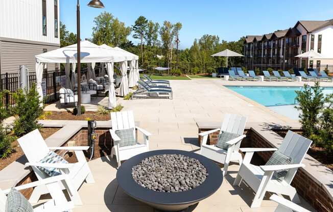 our apartments have an outdoor patio with chairs and a fire pit
