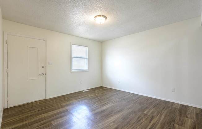 A room with wooden flooring and a window at Spring Creek Townhomes Apartments, Springfield 62702