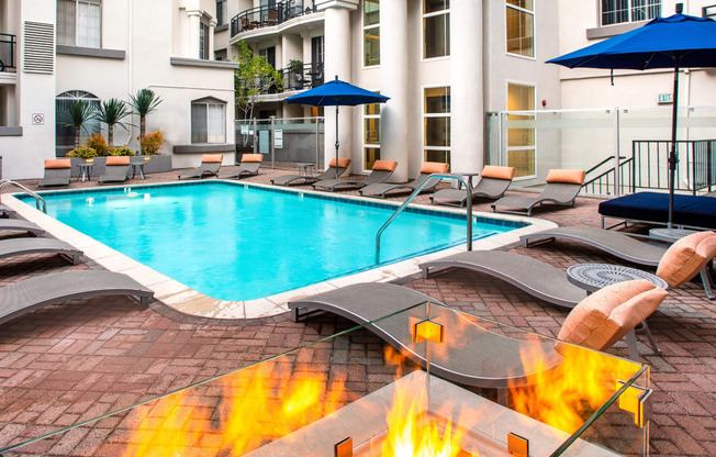 Apartments in Miracle Mile Los Angeles, CA- The Preston- Sparkling Pool with Sun Lounge Chairs and Nearby Firepit