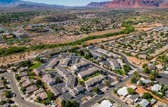 an aerial view of a suburban neighborhood with mountains in the background