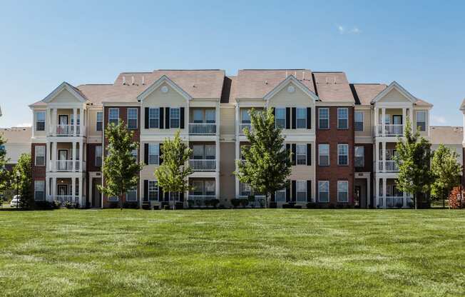 an image of an apartment building on a green lawn