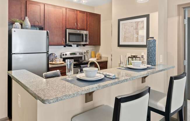 a kitchen with granite counter tops and stainless steel appliances