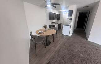 A photo of a living room with a dining table and chairs.