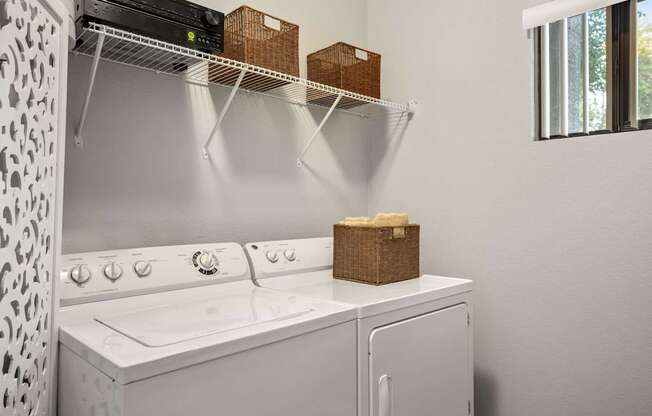 A white washing machine with a basket on top of it.