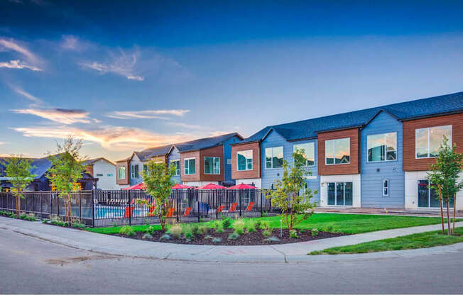 a row of houses with a street in front of them