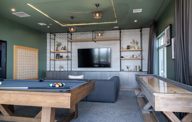 Rooftop game room with shuffleboard, billiards & large TV.