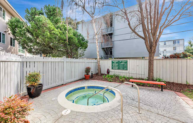 A small hot tub sits in the middle of a patio.