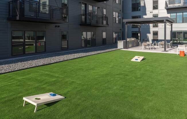 a yard with a table and chairs on the grass